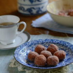 Gluten-free Pumpkin Rice Donuts are served with a cup of tea.