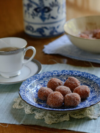 Gluten-free Pumpkin Rice Donuts are served with a cup of tea.