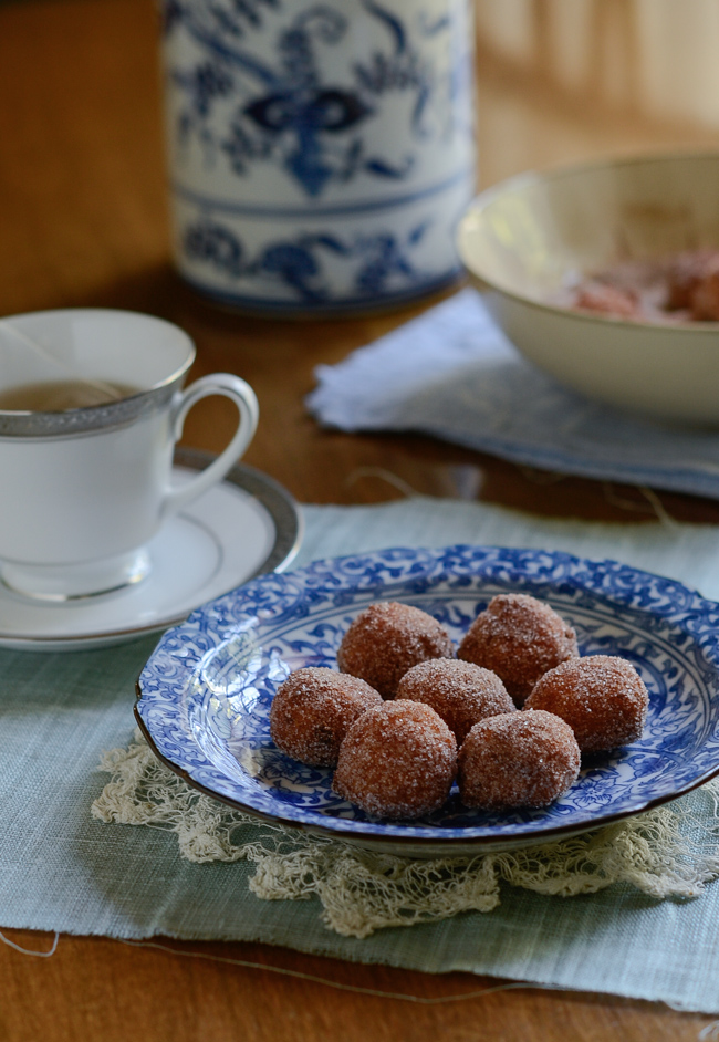Gluten-free Pumpkin Rice Donuts are served with a cup of tea.