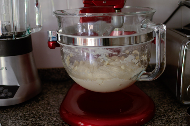 A standing mixer is doing the kneading job for making white chocolate bread dough.