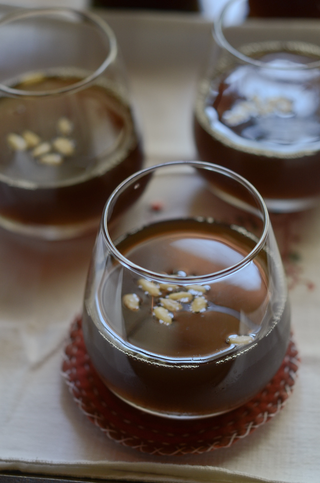 Korean Cinnamon Ginger Punch is sweetened with brown sugar, and garnished with pine nut