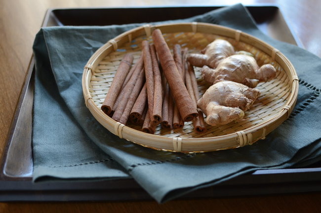 Cinnamon and ginger are placed in a wooden weaved plate to make Korean punch.