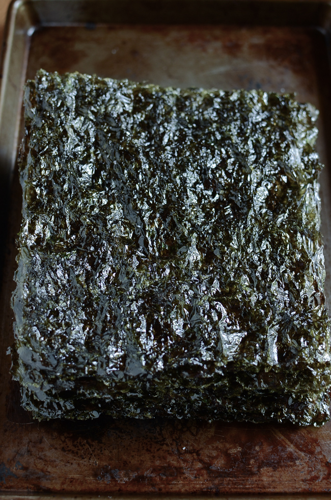 Stacks of homemade roasted seaweed sheets are showing their sheen.