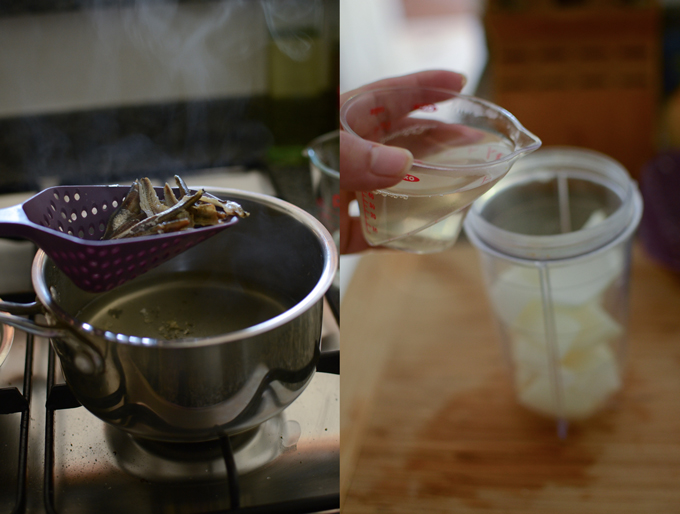 Anchovy stock is added to onion and garlic in a mini blender.