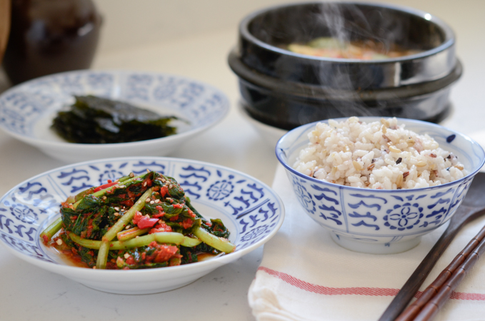 Turnip green kimchi is served with rice, doenjang jjigae and seaweed.