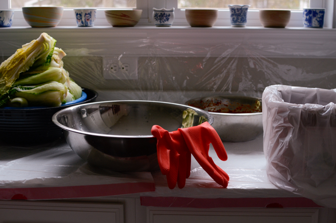 A Kitchen counter is lined with plastic to protect from the kimchi stain.