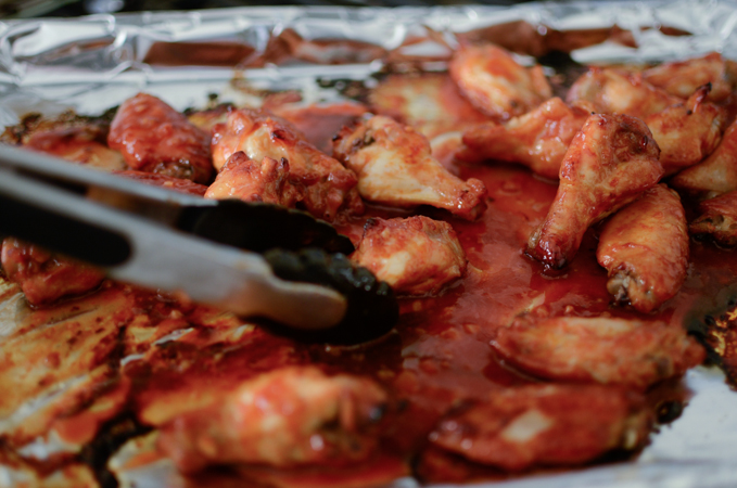 Baked wings are rubbed with the extra reserved sauce