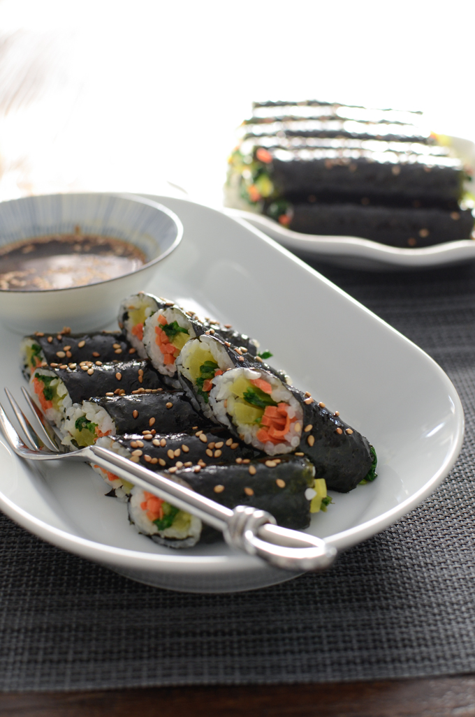 Serve mini seaweed rice rolls (Mayak Gimbap) with a mustard dipping sauce.