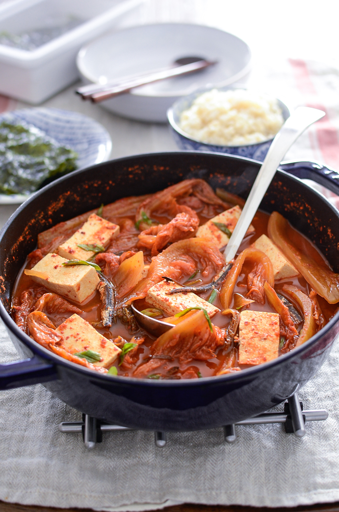 Anchovy Kimchi Stew is simmered with tofu and served with rice and roasted seaweed.