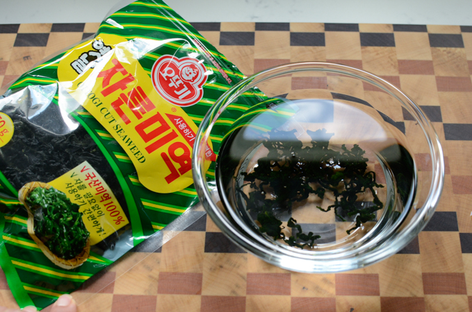 Dried seaweed in a bowl of water.