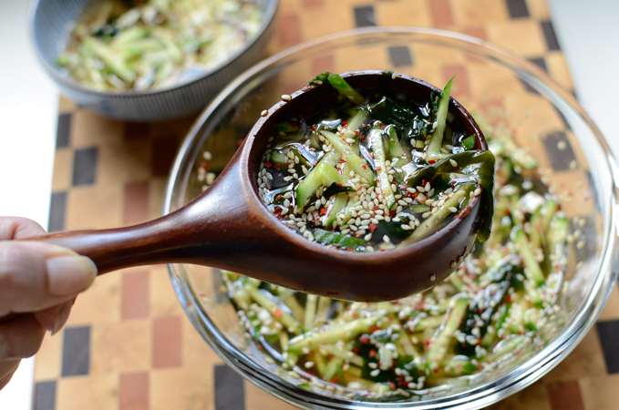 A ladle holding Korean cold seaweed soup.