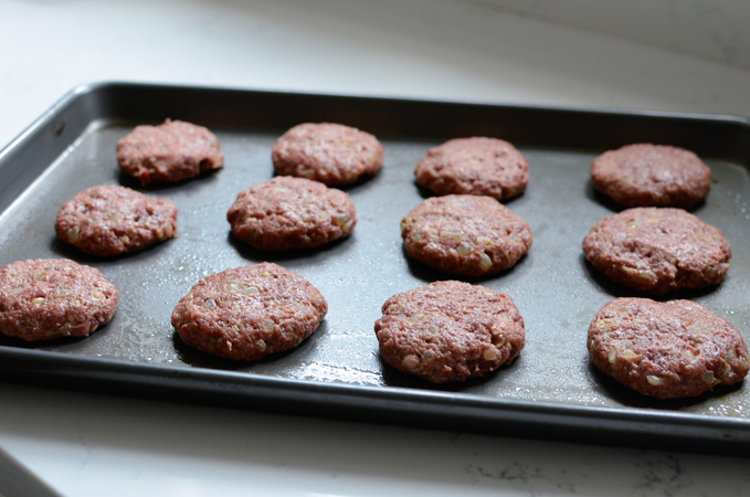 Small patties are placed and flattened on a greased baking sheet 