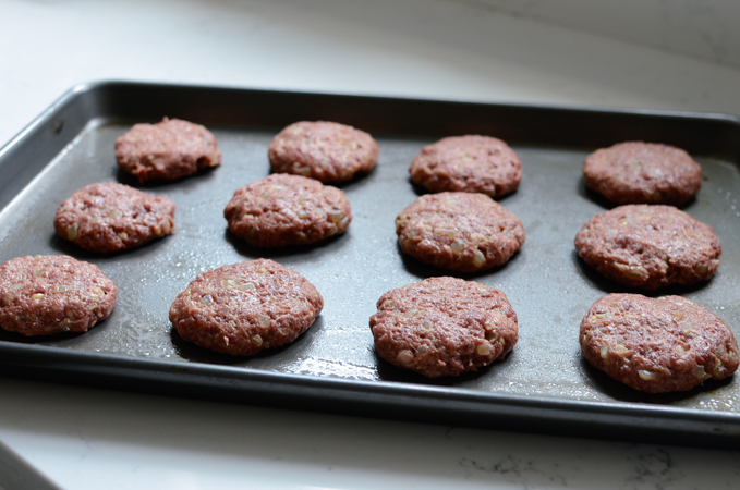 Small patties are placed and flattened on a greased baking sheet 