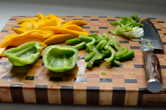 Mango and bell pepper strips to add to mango chicken stir-fry.