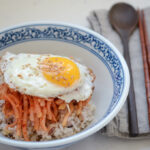 Radish salad rice bowl with a fried egg on top.