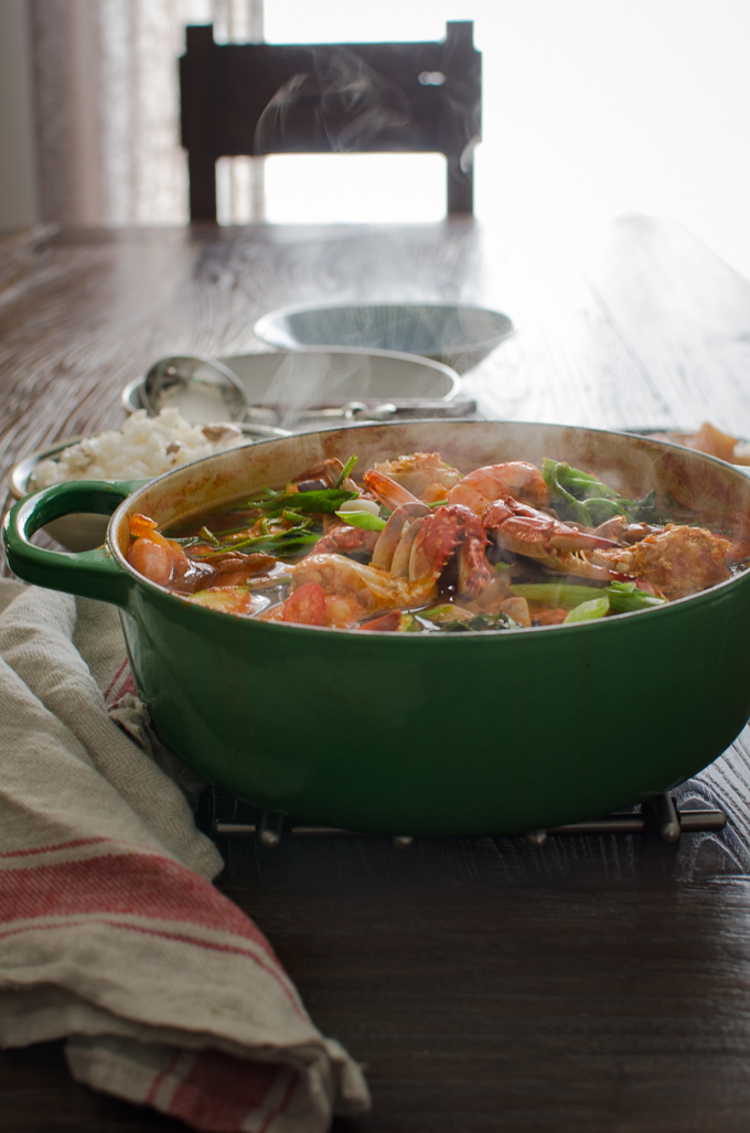 Korean Crab Stew made with fresh crabs and shrimp is steaming hot in a pot.