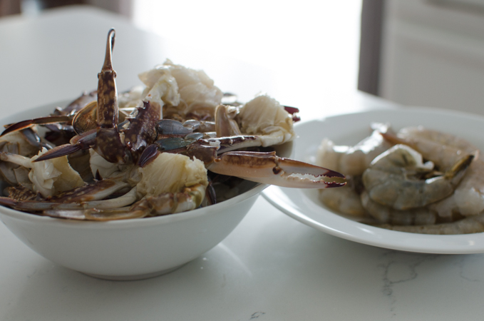 Cleaned crab pieces and shrimp are in the bowls.