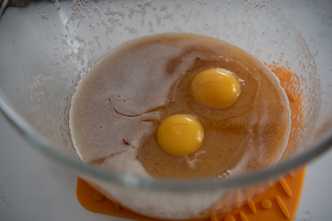 Brown butter combined with sugar and eggs in a bowl.