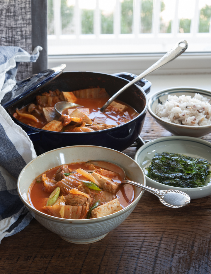 Kimchi Stew (Kimchi Jjigae) with Tomatoes is served with rice and roasted seaweed.