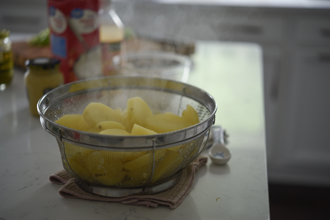 Cooked potato drained in a colander.