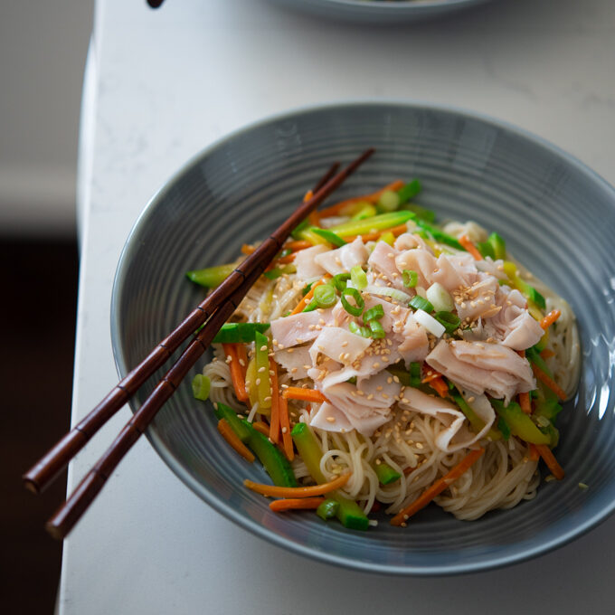 One Pot Korean Noodles and Vegetables are topped with lunch ham slices.