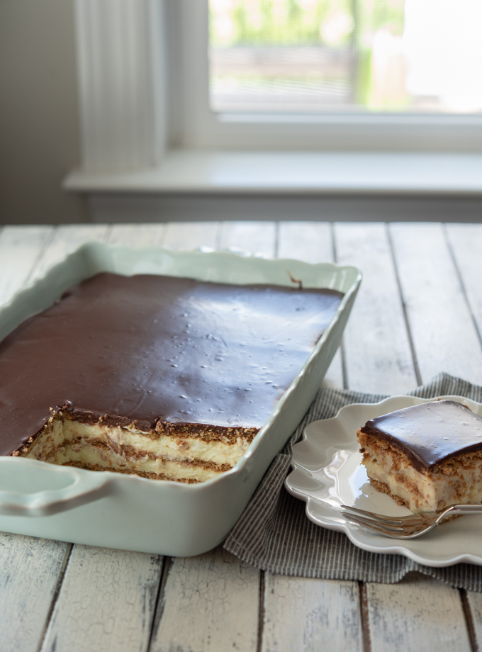 No-bake eclair cake made from scratch with graham crackers, vanilla custard, and chocolate ganache.