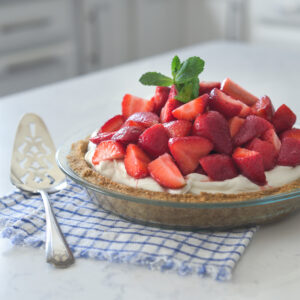 Strawberry mascarpone cream pie is made with a graham cracker crust