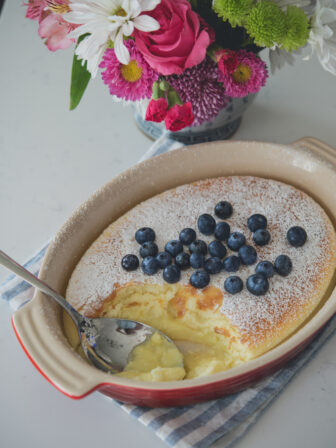 Feather-light lemon pudding cake is spooned with custard filling and fresh blueberries.