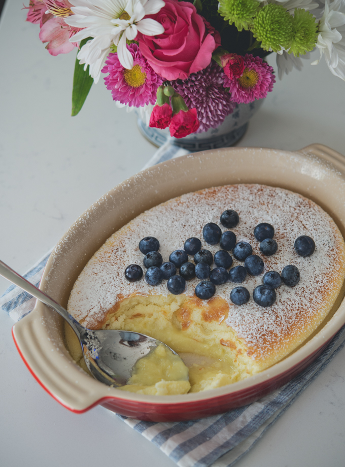 Feather-light lemon pudding cake is spooned with custard filling and fresh blueberries.