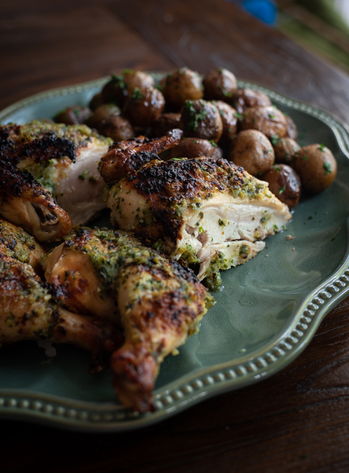 Pollo Diablo is cut up and served with roasted potatoes.
