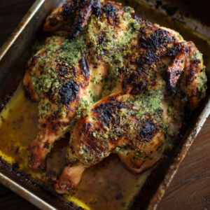 Devil's chicken is a roasted spatchcock chicken rubbed with butter parsley paste.