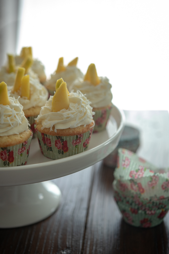 Mango cupcakes are lined with floral cupcake liners