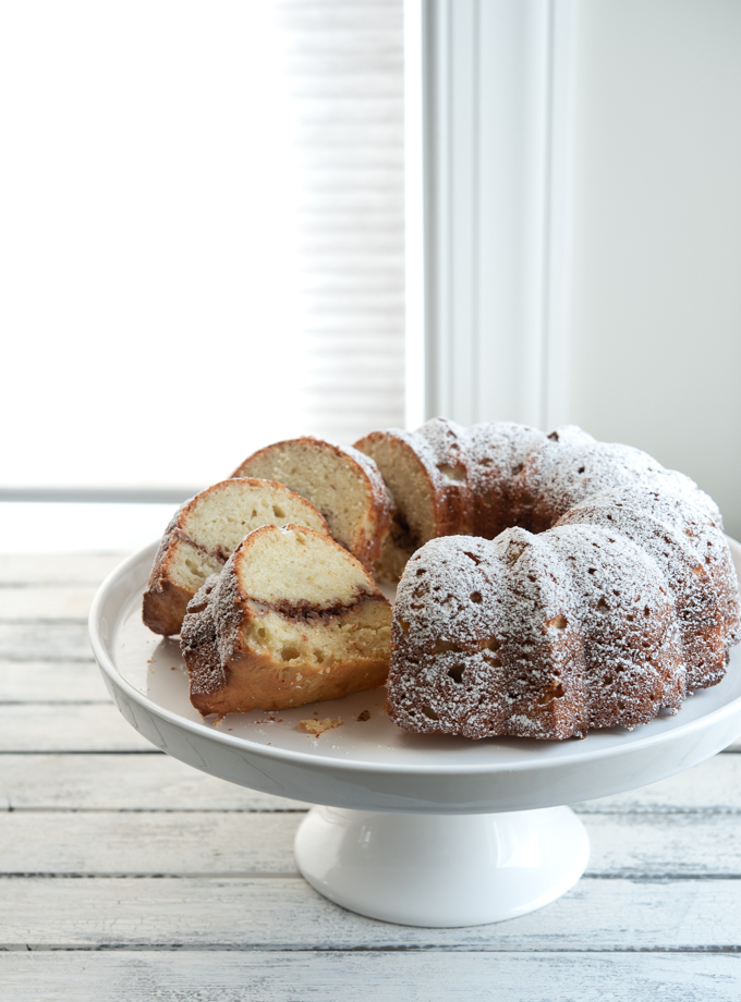 This apple bunt cake has walnut cinnamon filling and dusted with powdered sugar.