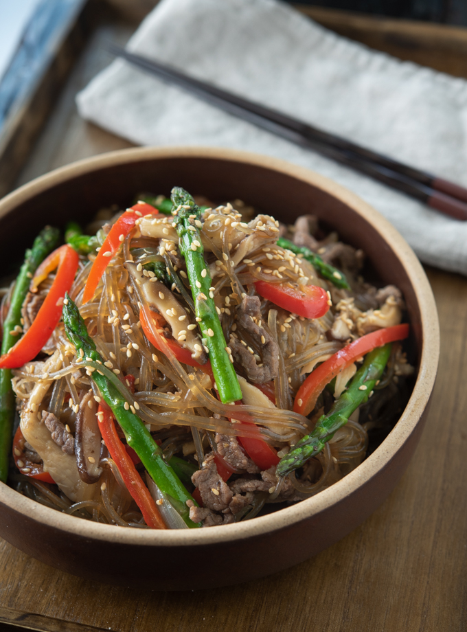 Beef Japchae is made with sweet potato noodles, Asparagus and Mushroom.
