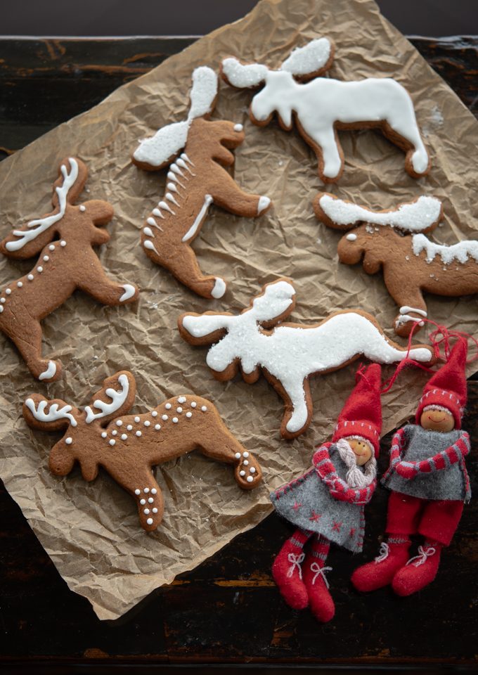 Traditional Swedish gingerbread cookies (Pepparkakor) is decorated with white icing.