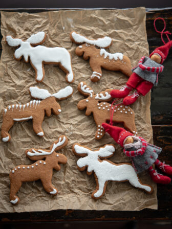 Traditional Swedish gingerbread cookies (Pepparkakor) is decorated with white icing.