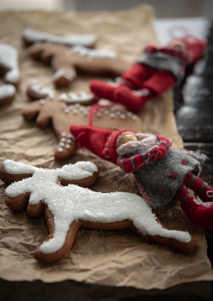 Scandinavian ginger cookies are decorated with simple white icing and sparkling sugar 