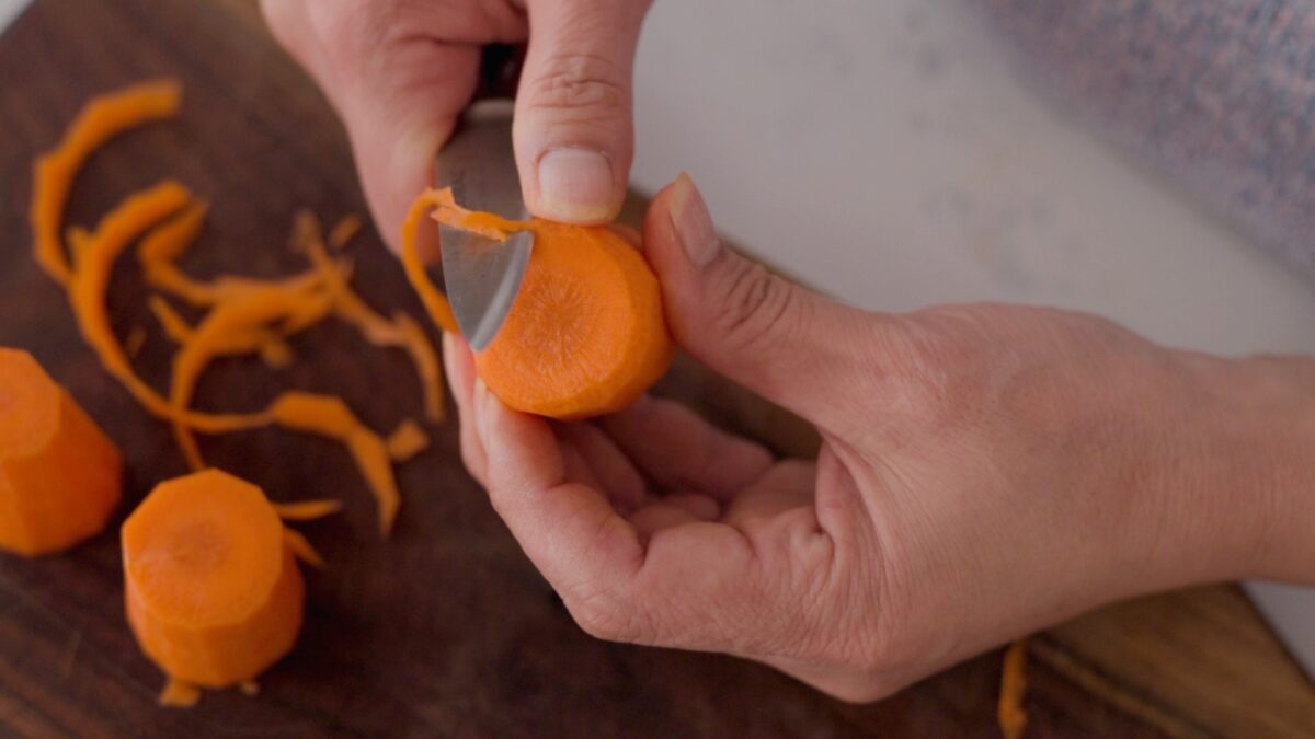 A piece of carrot is rounded on the cut side to have a smoother edge.