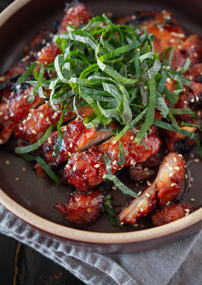 Chicken bulgogi (Korean bbq chicken) made with gochujang is garnished perilla leaves.