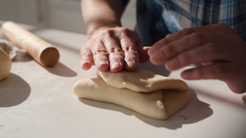 Folding the Japanese milk bread dough to thirds.