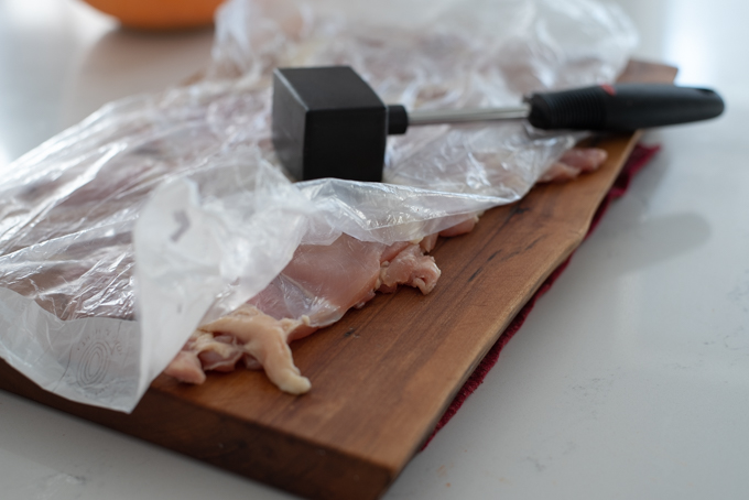 Pound chicken with a meat hammer to tenderize