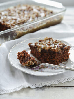 A slice of chocolate oatmeal cake is on a plate with a fork