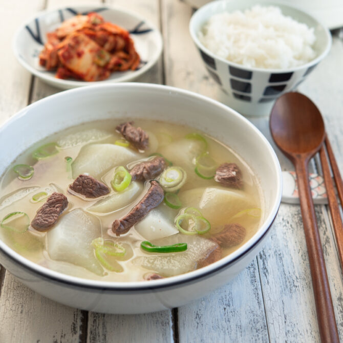 Korean beef radish soup is served with rice and kimchi