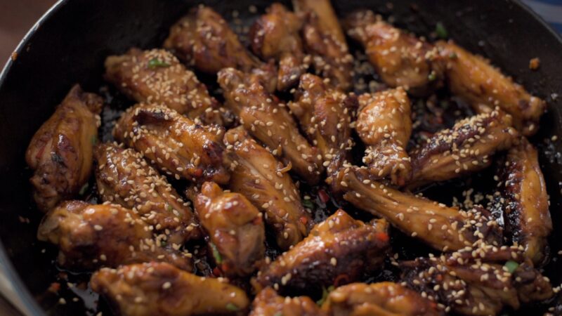 Toasted sesame seeds is used to garnish Korean honey garlic chicken wings.