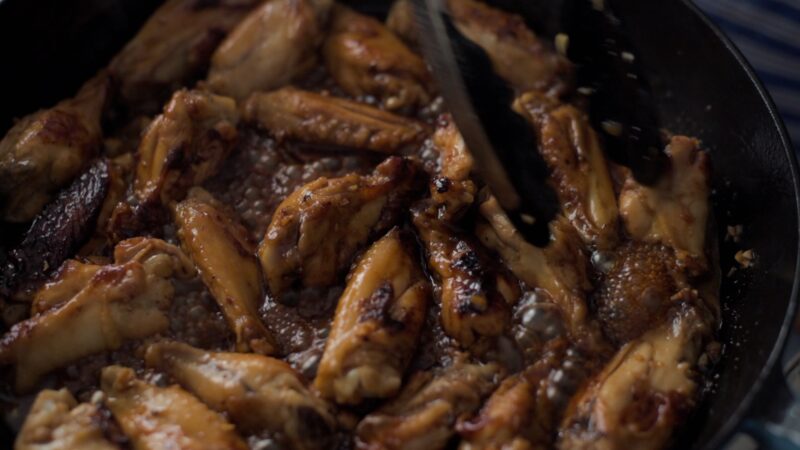 Chicken wings are cooking in honey garlic sauce