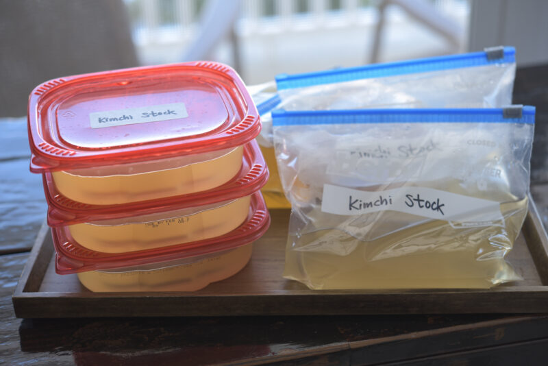 Plastic containers and zip bags and filled with soup stocks.