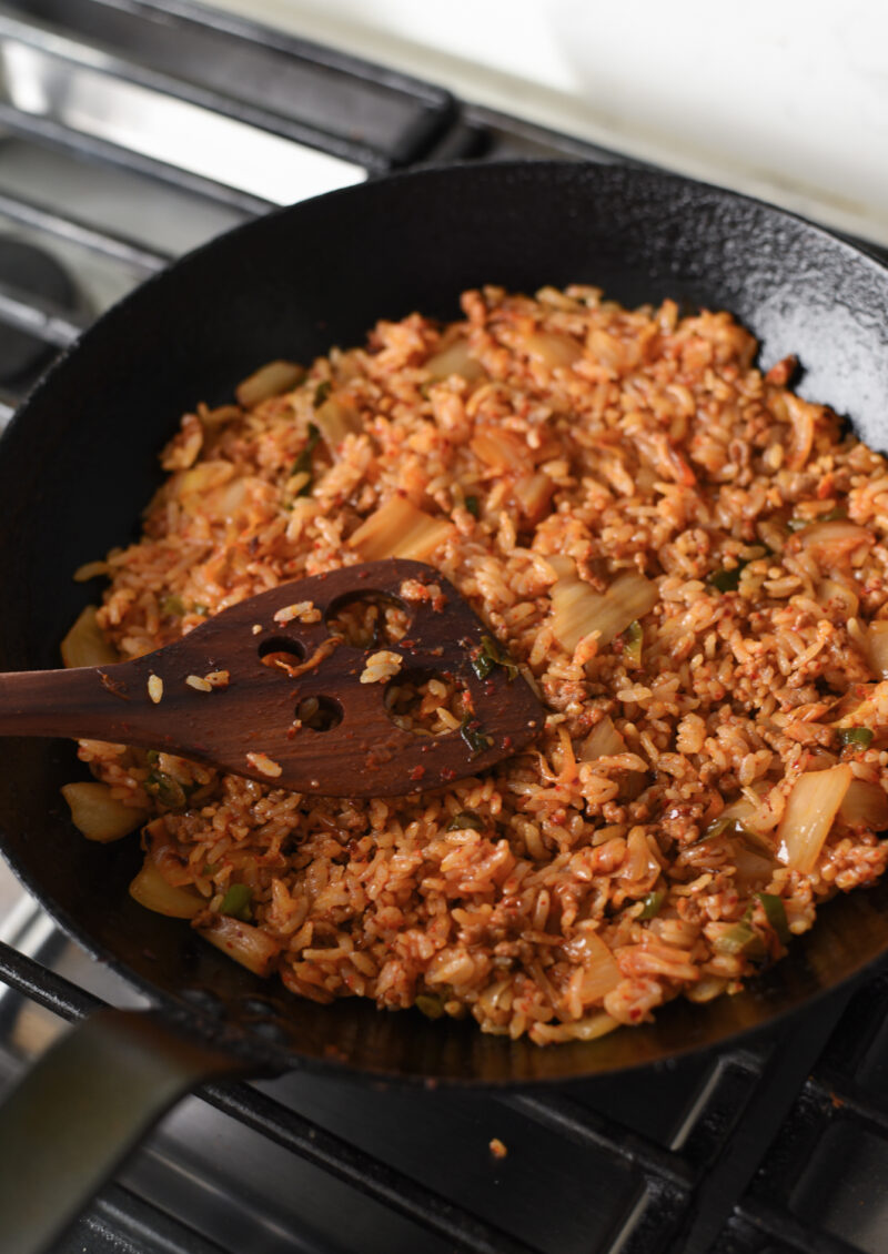 press kimchi fried rice gently to the cottom of a skillet
