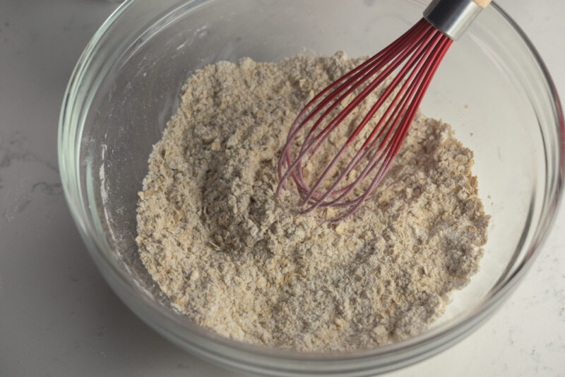 Dry ingredients for chocolate wheat germ cookies are whisked together.