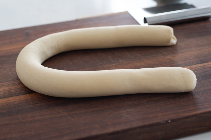 Dumpling dough shaped into a log with 1 1/2 inch diameter.