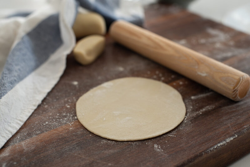 Use a rolling pin to make round shape of wrappers